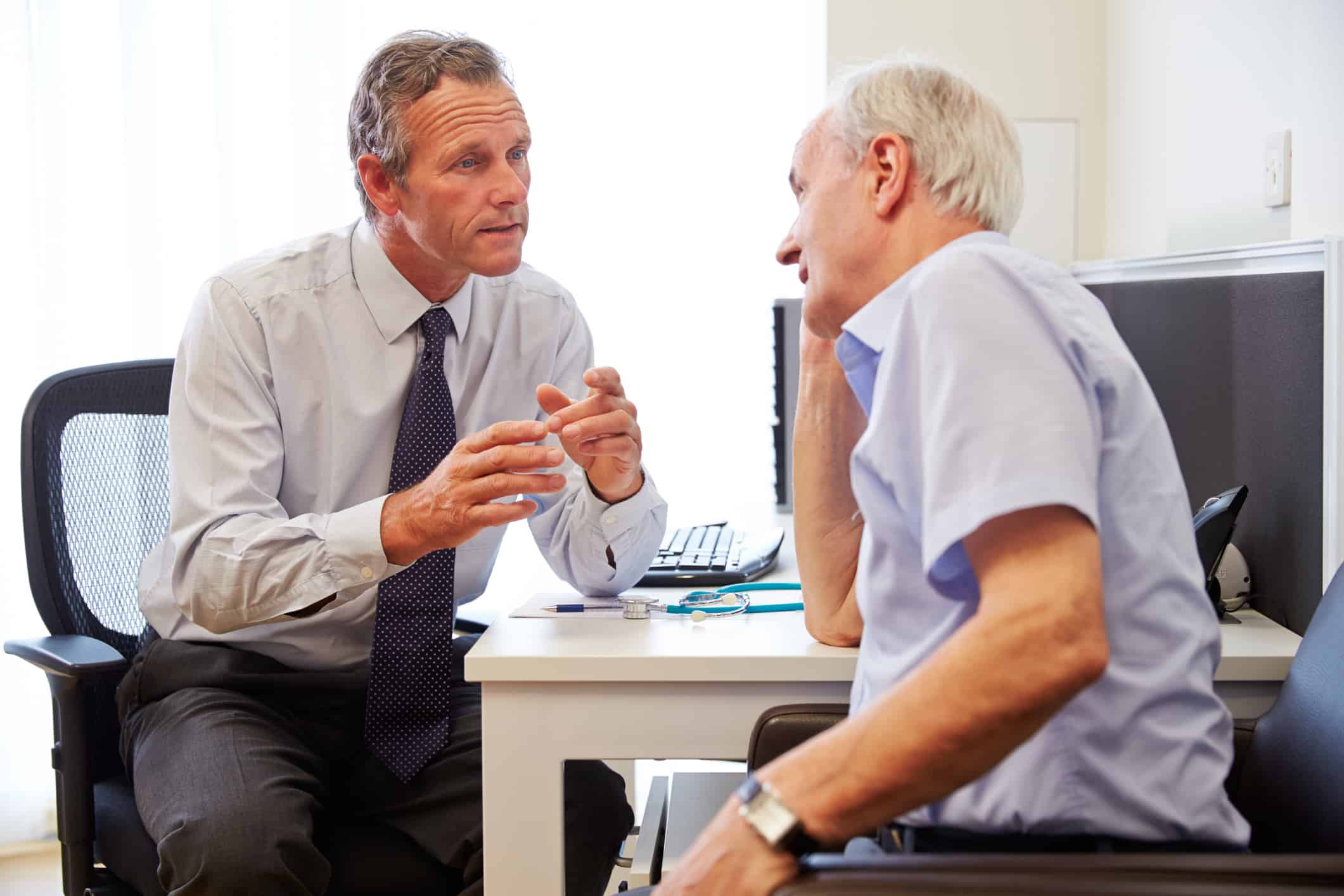 Senior Patient Having Consultation With Doctor In Office