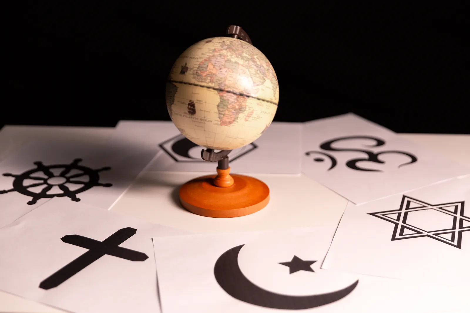 Globe surrounded by the symbols of the world's major religions
