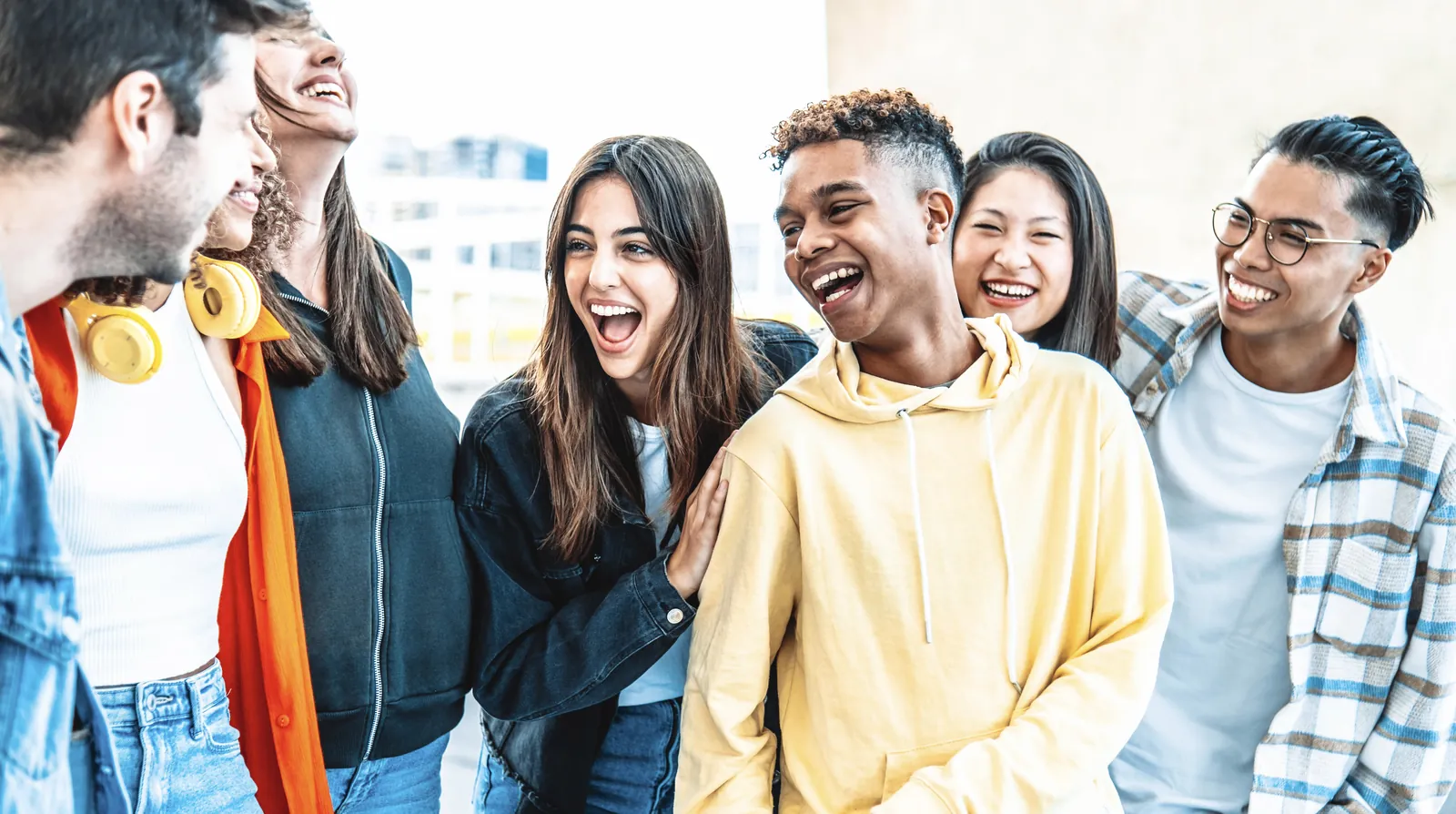 Group of friends laughing together outdoors