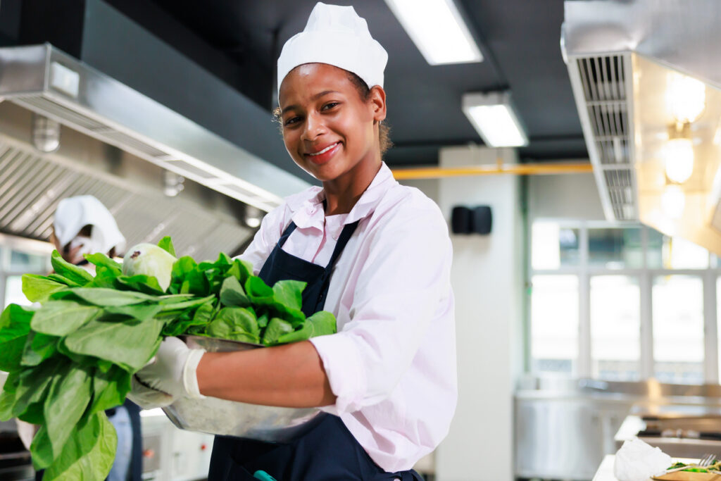 Hospital hospitality worker preparing food in a healthcare kitchen for Hospitality Workers in HealthCare Day