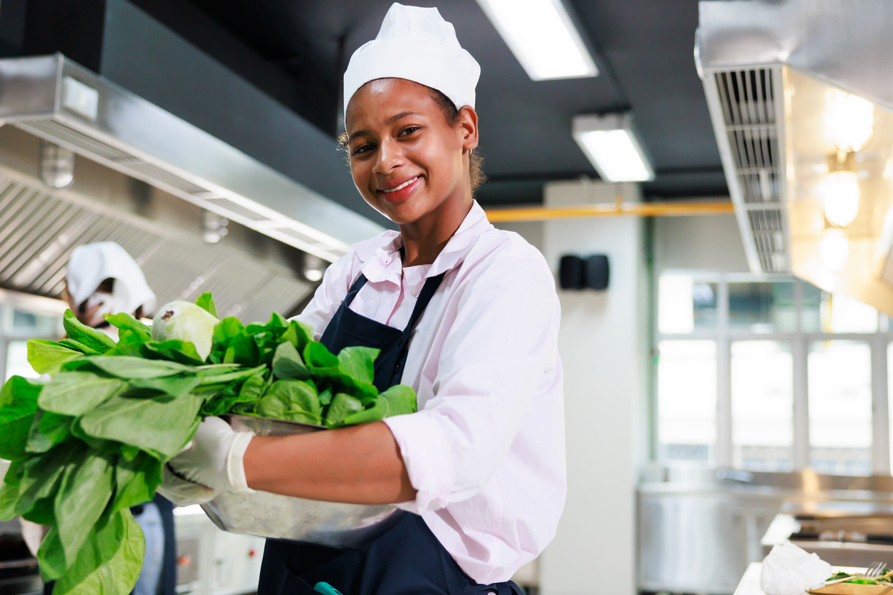Hospital hospitality worker preparing food in a healthcare kitchen for Hospitality Workers in HealthCare Day