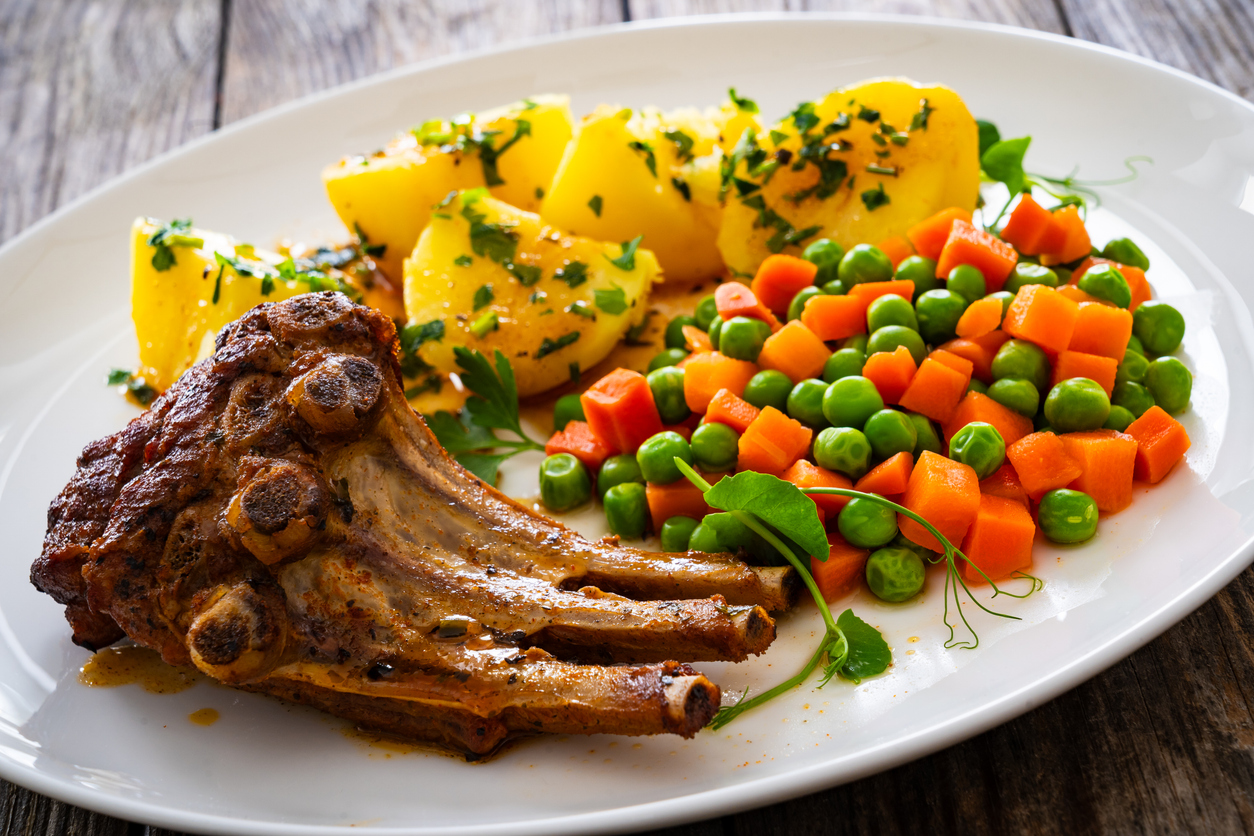 Crown roast of pork served on a platter for National Crown Roast of Pork Day