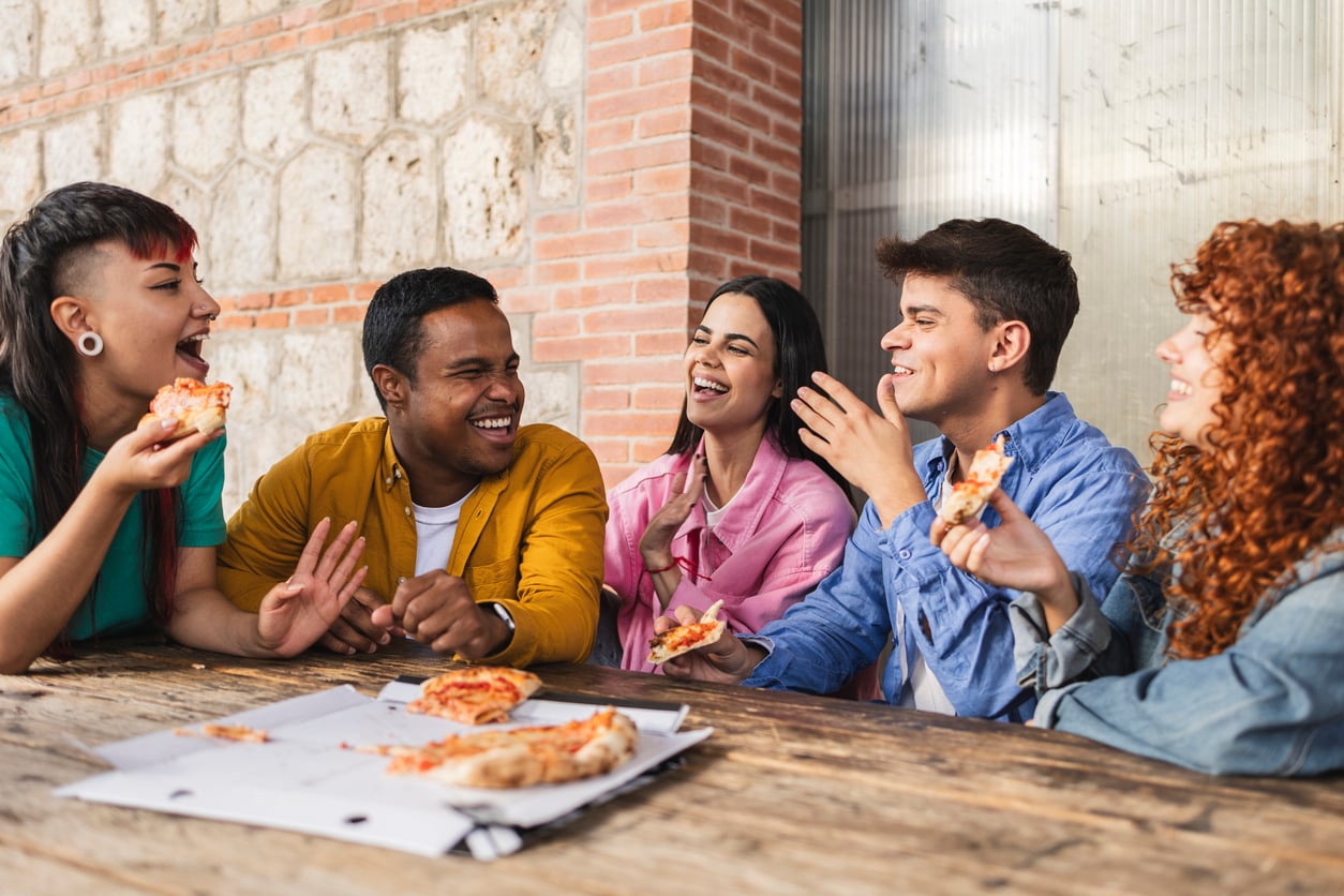 Friends enjoying pizza together for National Pizza Party Day