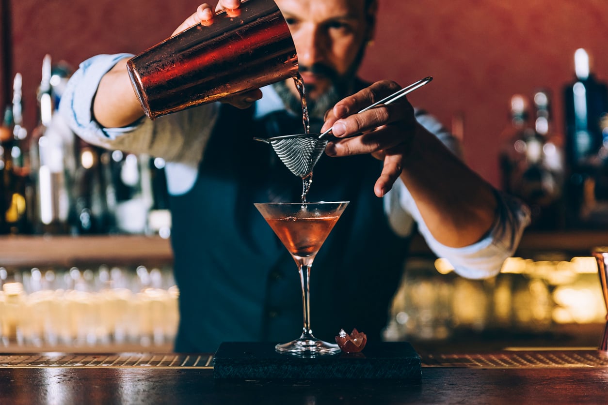 Bartender mixing a cocktail for World Bartender Day