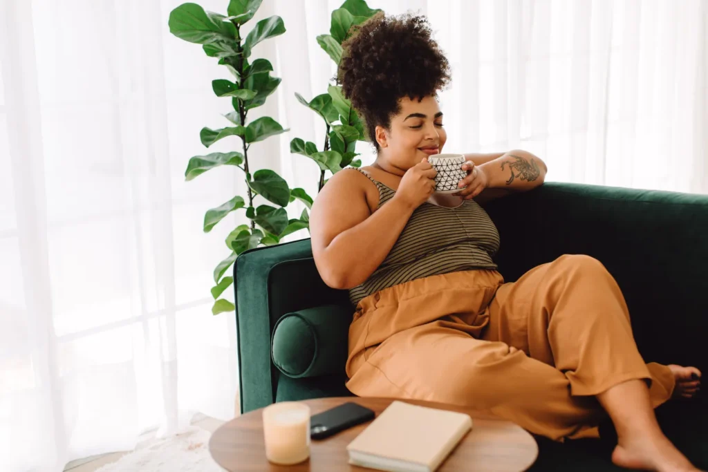 Black Girl Day Off: a woman relaxing at home with a hot drink