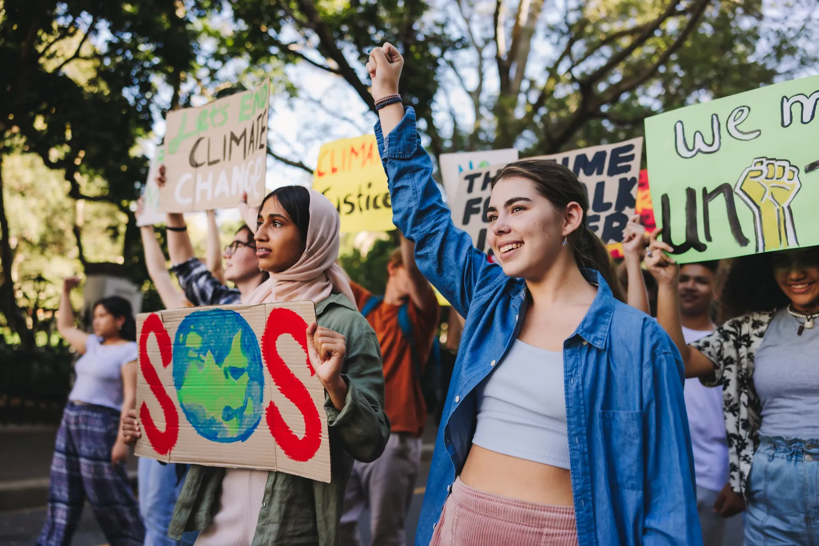 International Day of Climate Action: young people holding climate protest signs