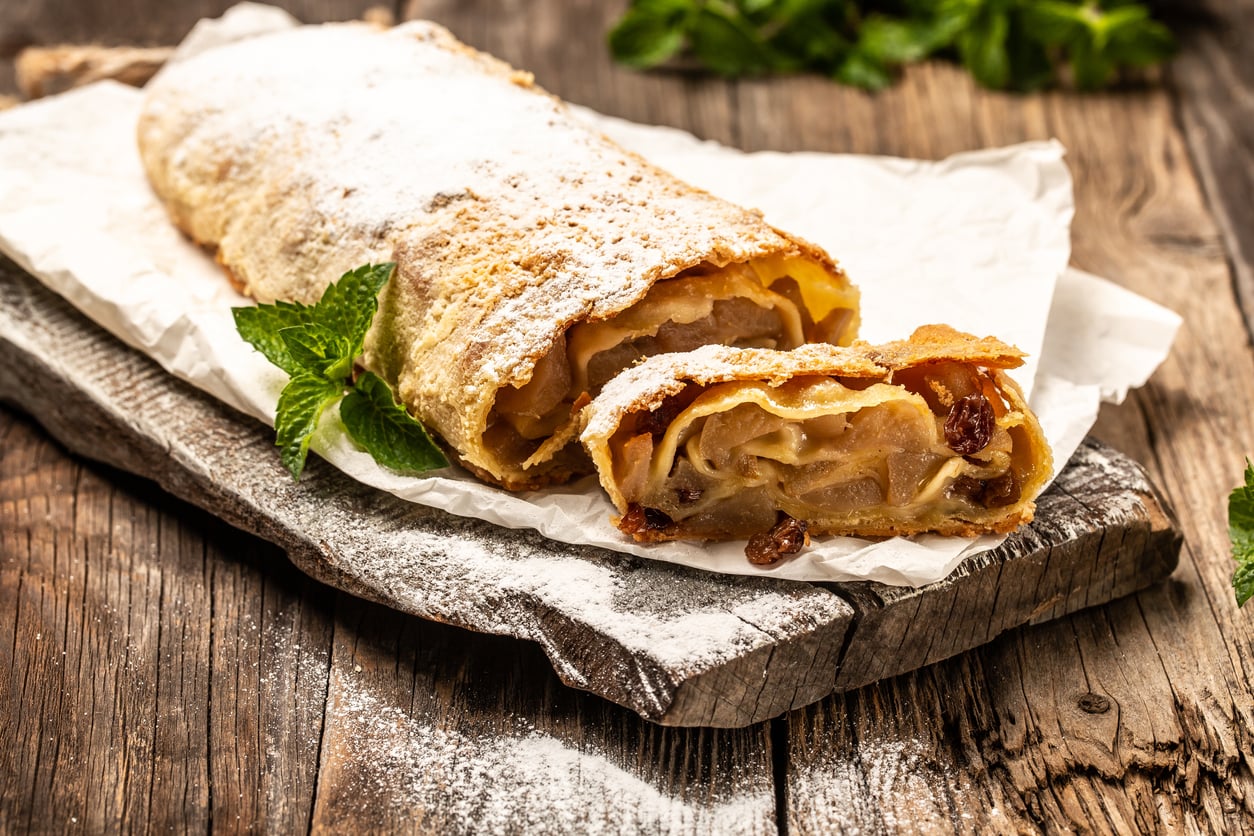 A slice of apple strudel dusted with icing sugar