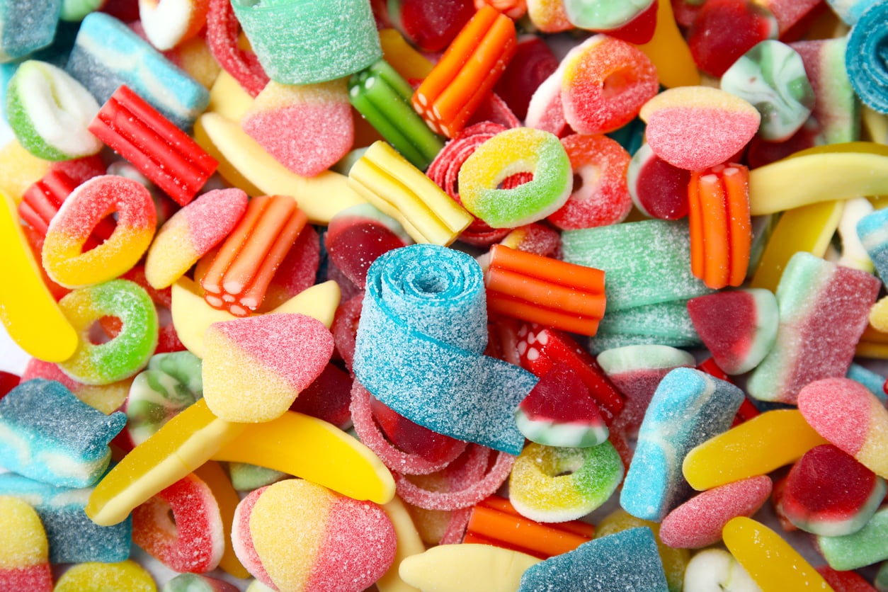 Colourful gummy worm sweets piled together for National Gummi Worm Day