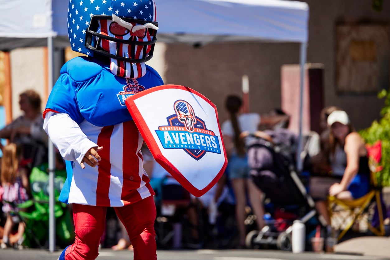 A colourful sports mascot costume entertaining fans at a stadium event for National Mascot Day