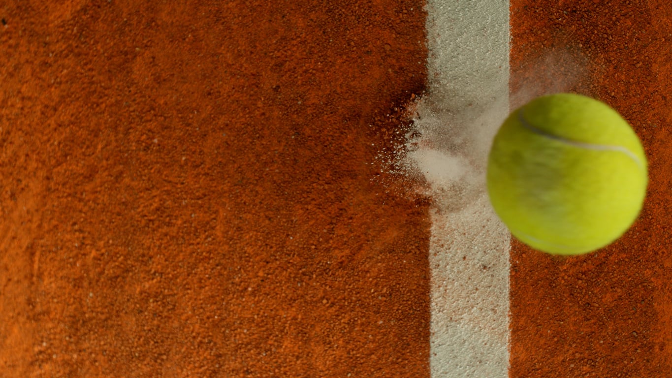 Tennis racket and ball on a court for International Tennis Day