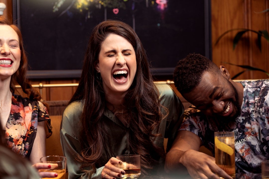 Friends laughing together, celebrating friendship on National Good Buddy Day