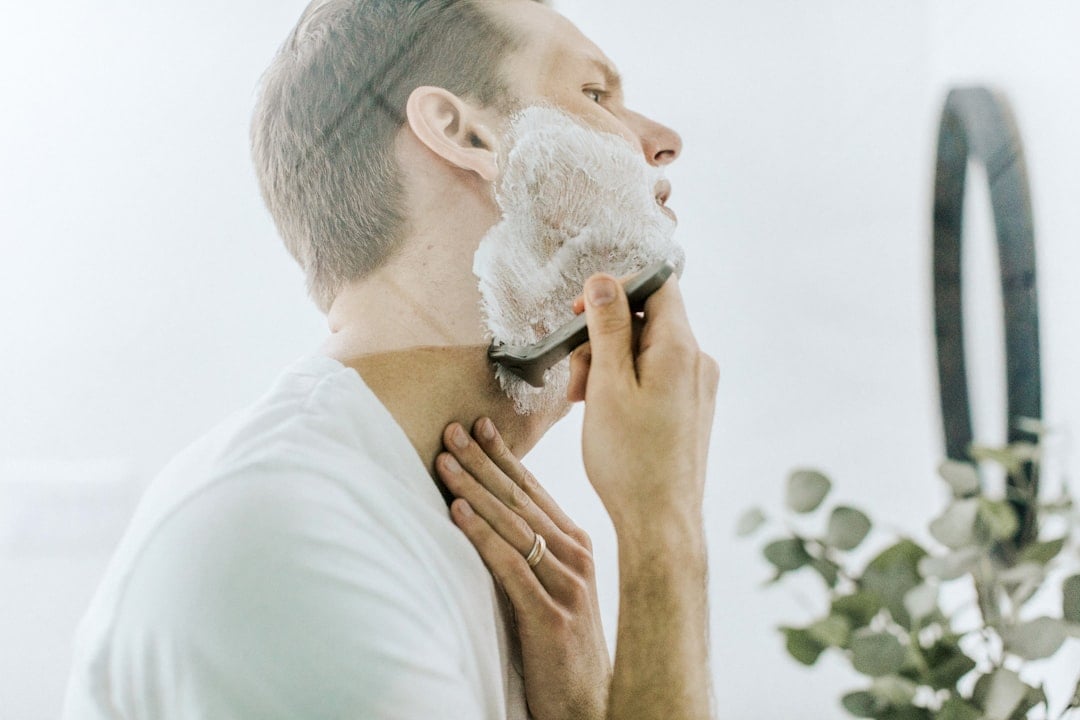 A man shaving his face for National No Beard Day