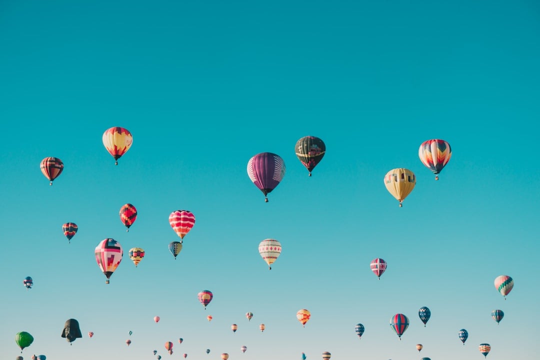 Colourful hot air balloons floating in a clear blue sky