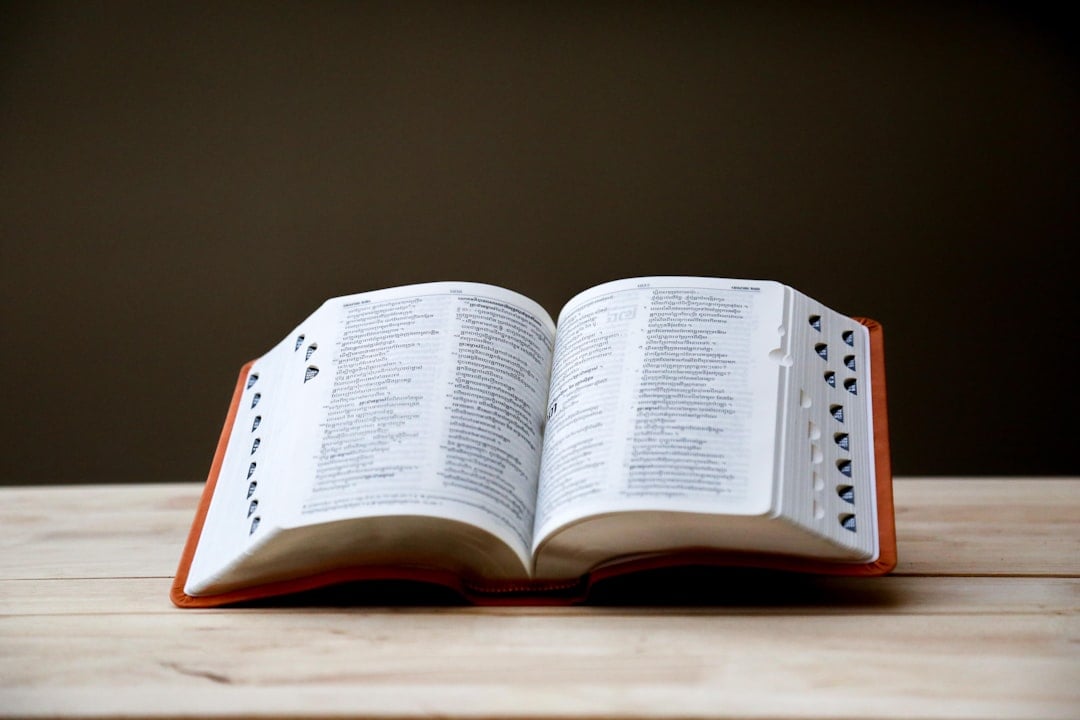Open dictionary showing pages of word definitions for National Dictionary Day