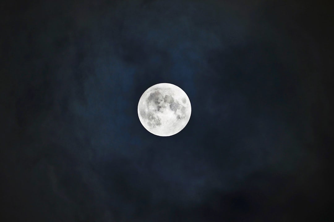 A bright full moon glowing in a dark night sky for Chant at the Moon Day