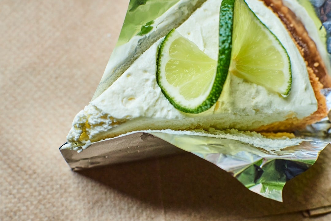 A slice of key lime pie topped with whipped cream