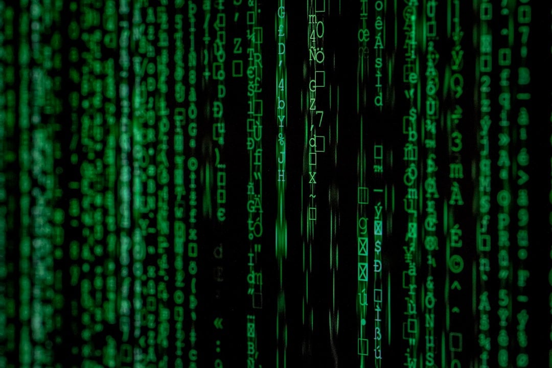 A cybersecurity professional working with code on multiple screens