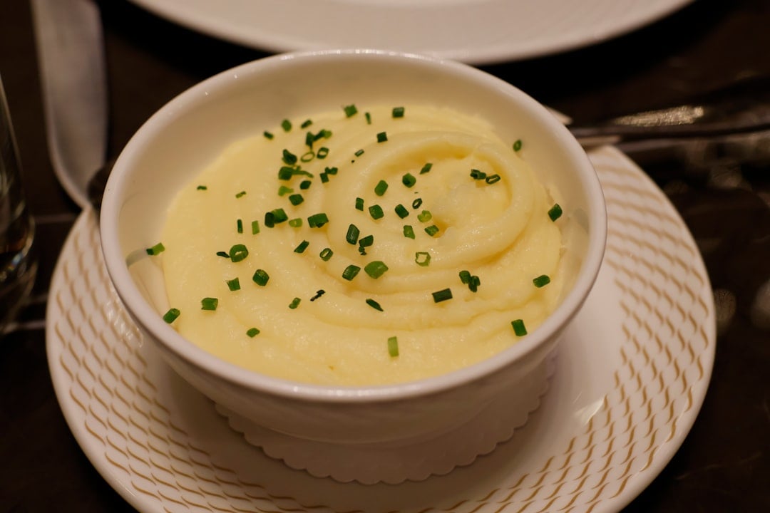 A bowl of creamy mashed potatoes with butter