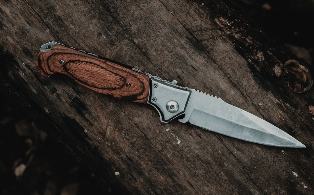 A folding pocket knife on a wooden surface