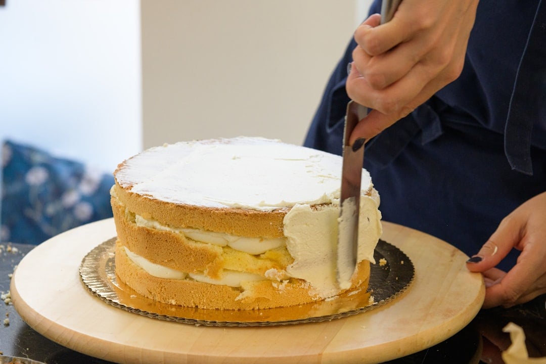 Decorating a cake with icing for National Cake Decorating Day