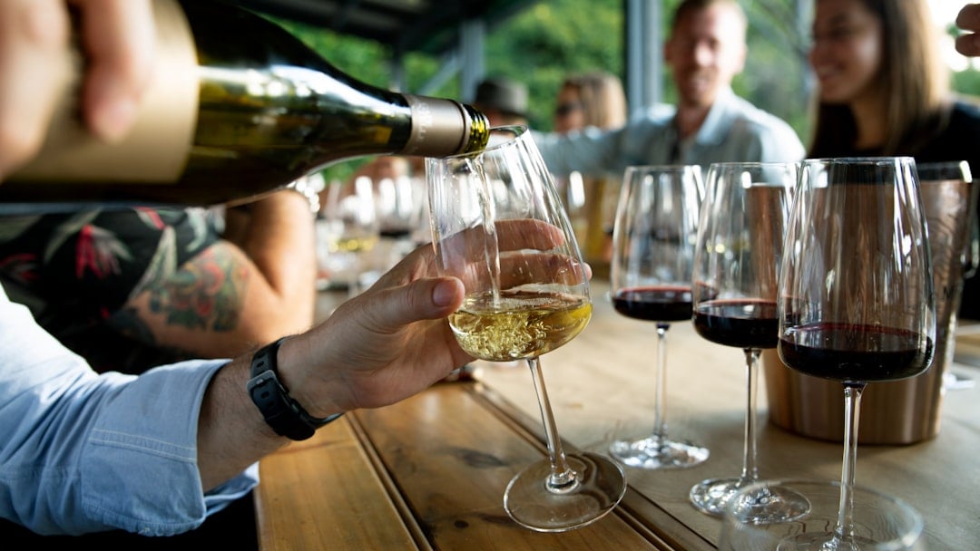 Sommelier pouring red wine at a tasting