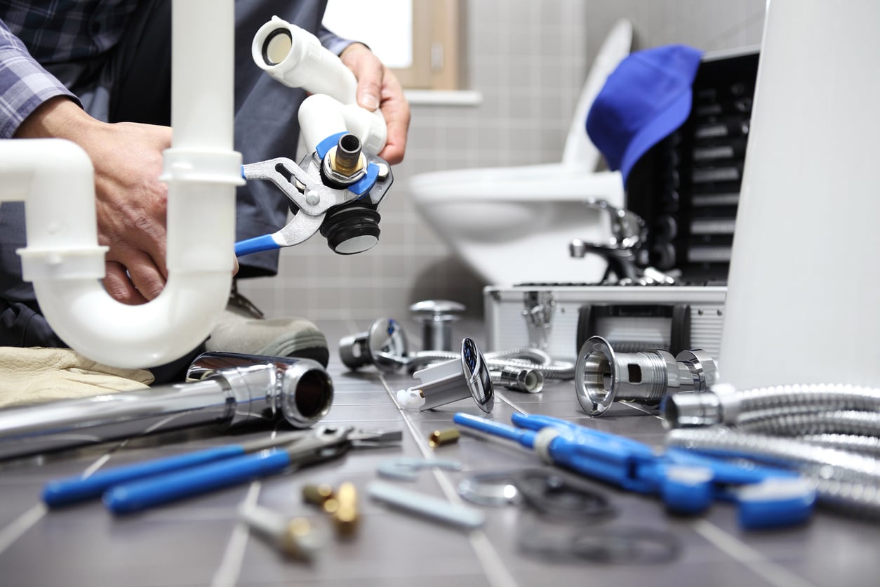Plumber fixing a toilet tank