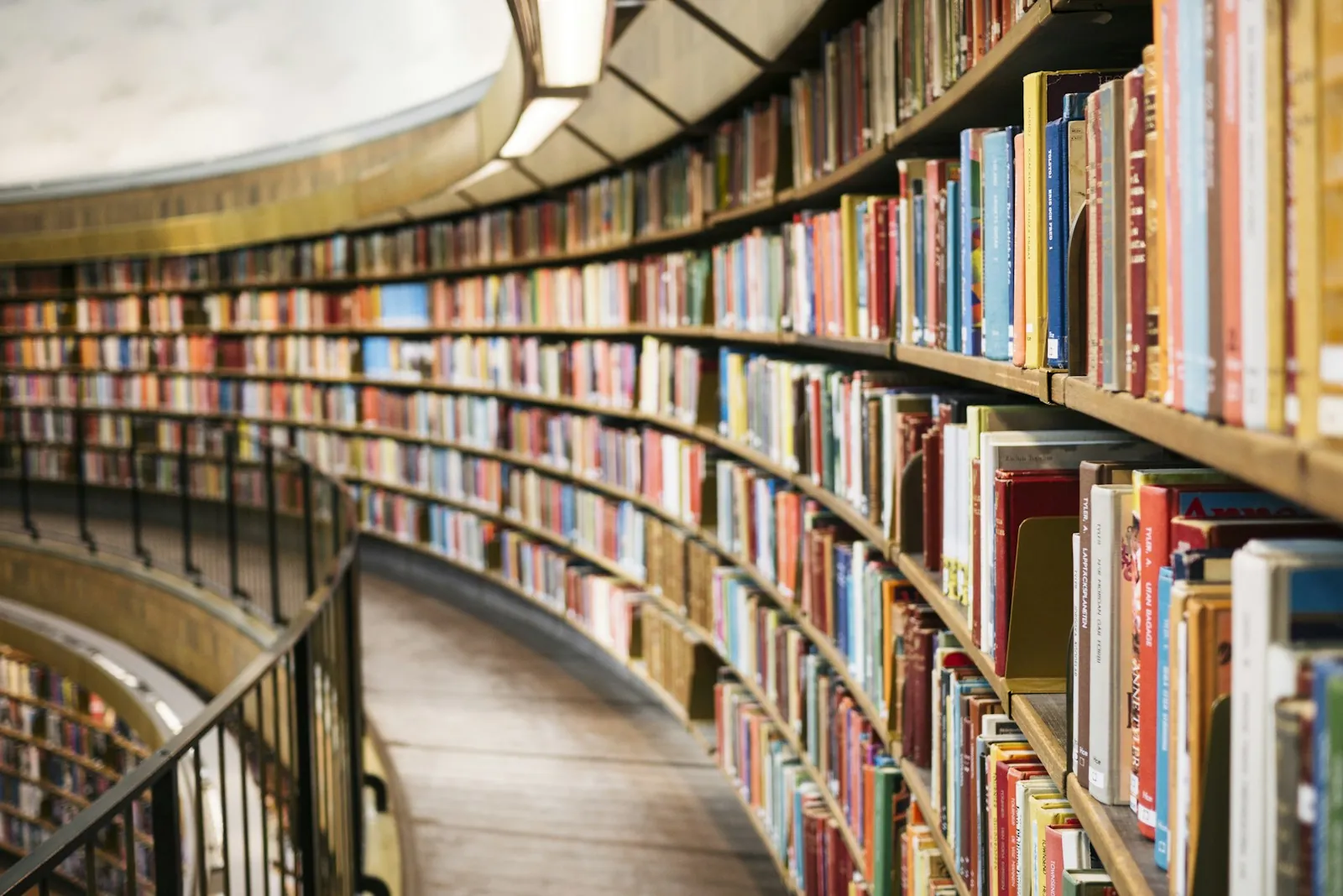 National Library Card Sign-up Month: curved shelves of books in a library