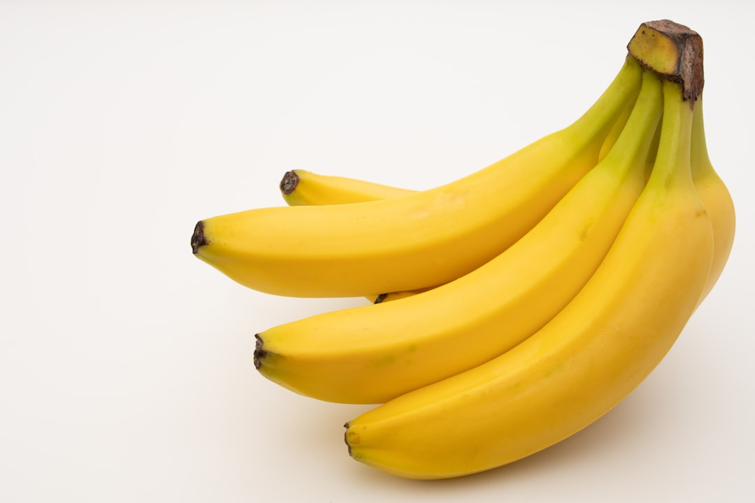 Fresh yellow bananas on a wooden surface