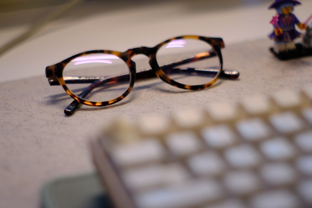 Person with glasses surrounded by books and technology, embracing their inner nerd