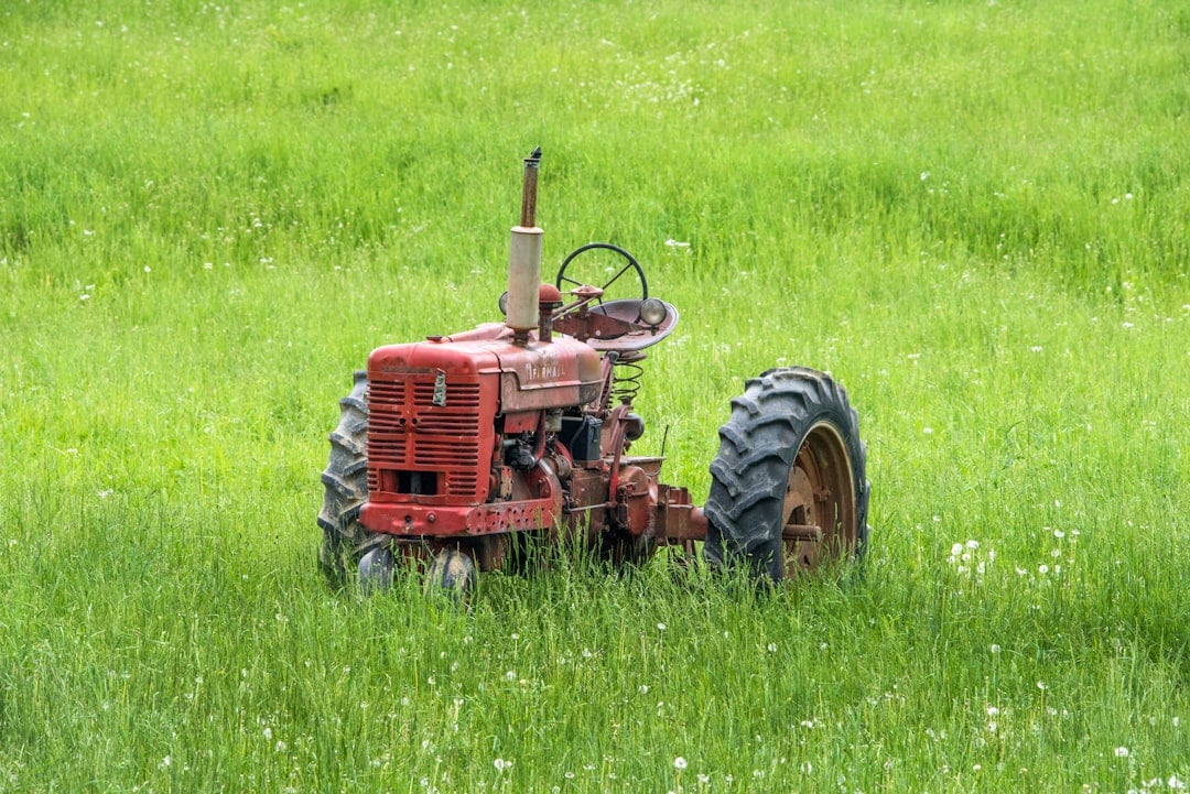 Vintage antique farm tractor in a field