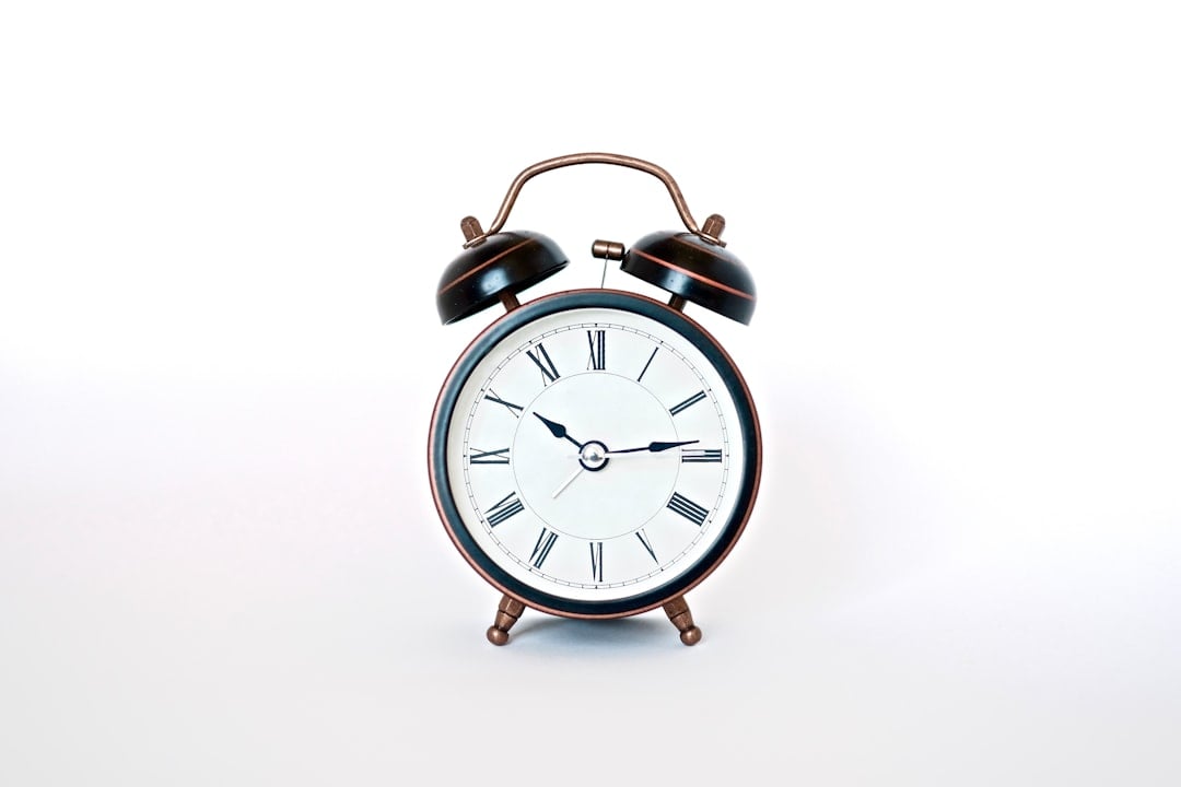 Alarm clock with person relaxing, celebrating National Be Late for Something Day
